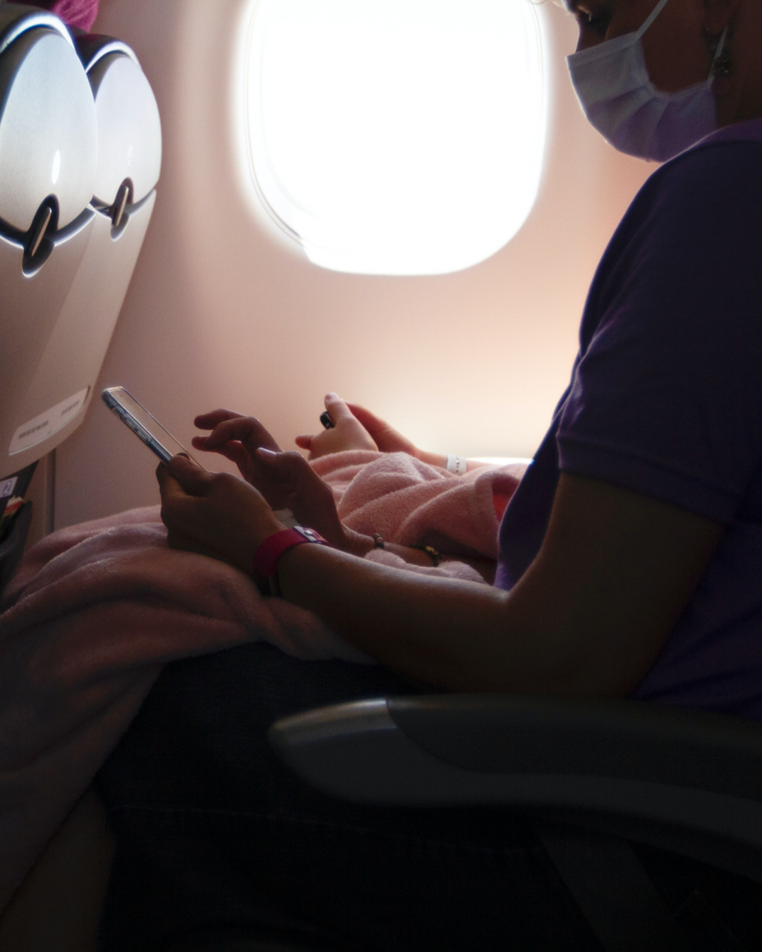 Flight passenger wearing mask while flying on airplane