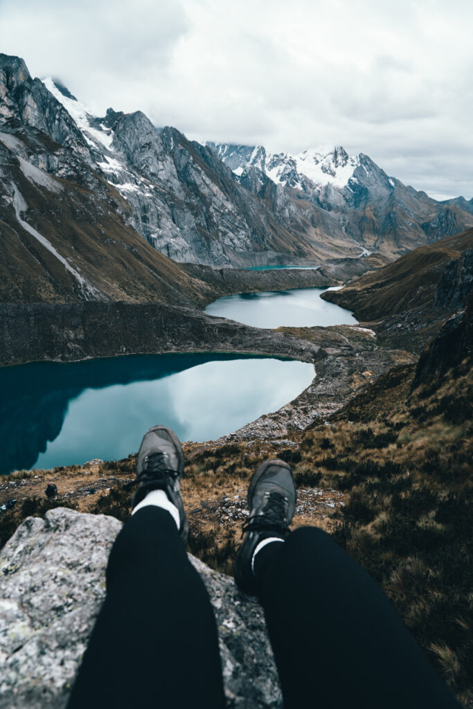 Hiking boots hanging over Mirador de Tres Lagunas or Three Lakes Viewpoint during Cordillera Huayhuash trek in Peru
