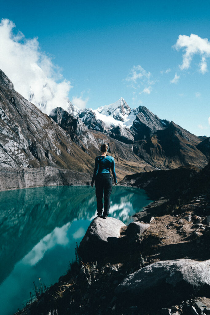 Woman standing in front of 3 lakes viewpoint at Cordillera Huayhuash in Huaraz Peru