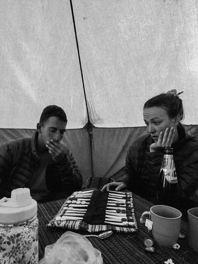 Two people playing games during Cordillera Huayhuash trek in Huaraz Peru