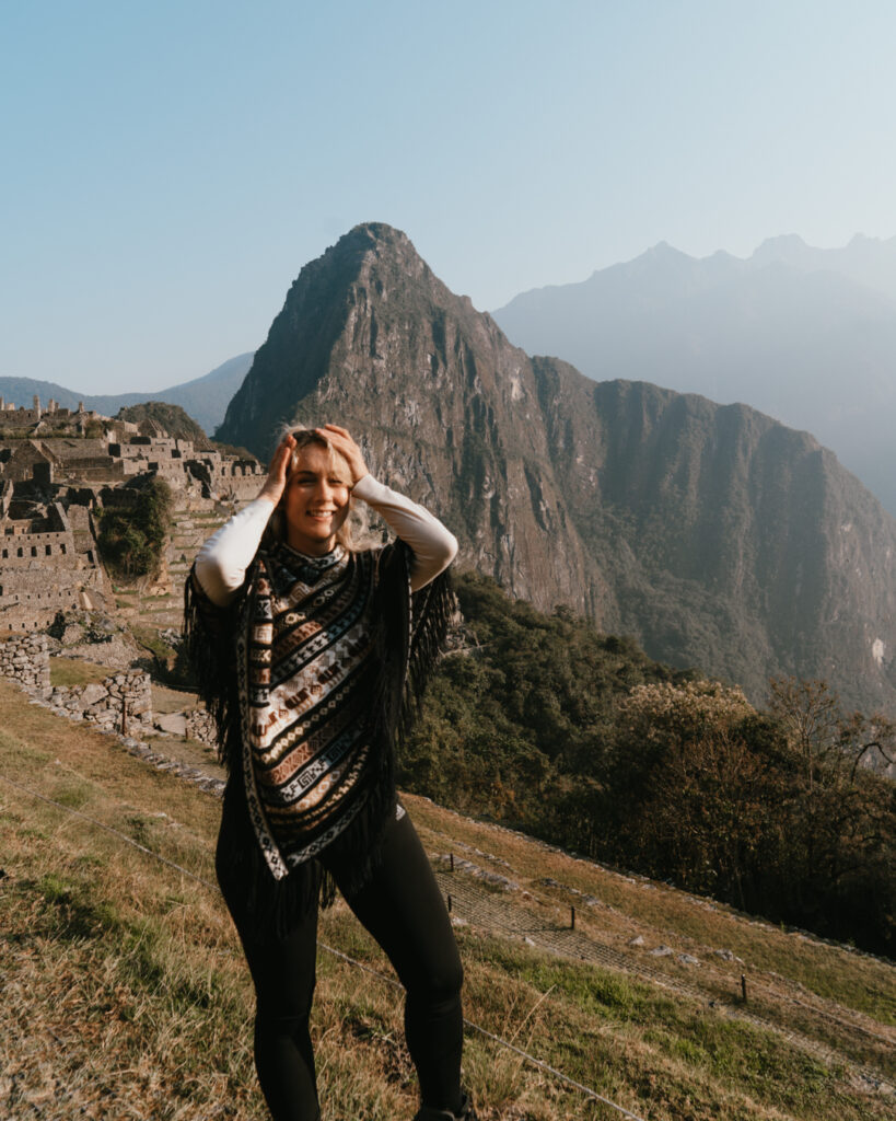 Solo female traveler posed in front of Machu Picchu