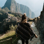 Woman walking down steps of Machu Picchu in Peru