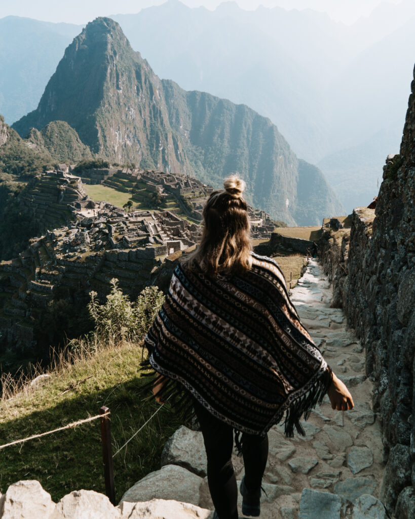 Woman walking down steps of Machu Picchu in Peru