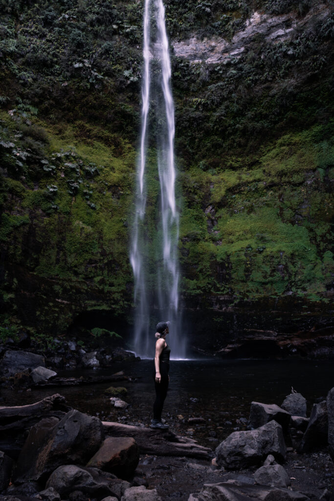 solo traveler woman exploring waterfall in Pucon Chile called Salto del Claro