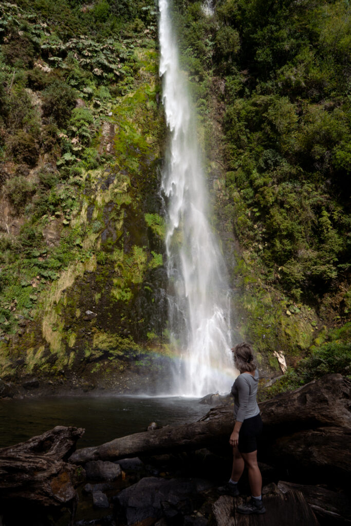 solo traveler woman exploring waterfall in Pucon Chile called La China