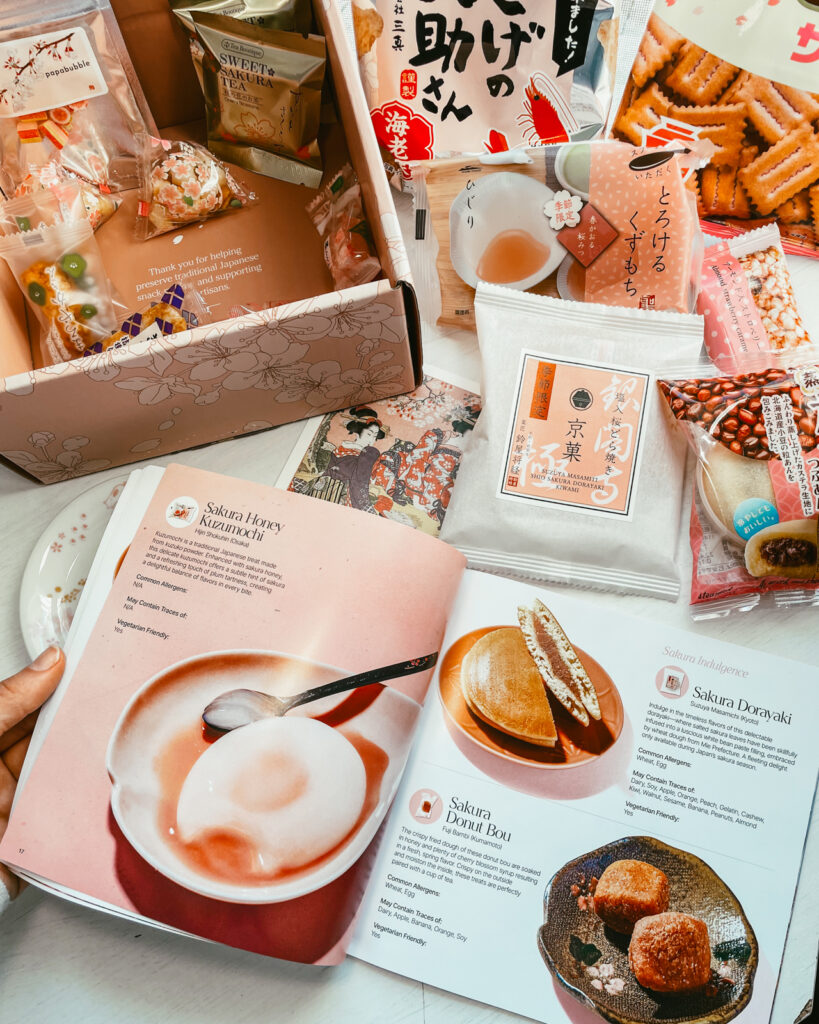 Open page of snack guide to Japanese snack box with treats