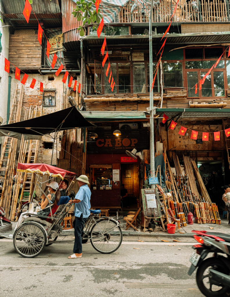 coffee shop front in Hanoi Vietnam with bike riding in front