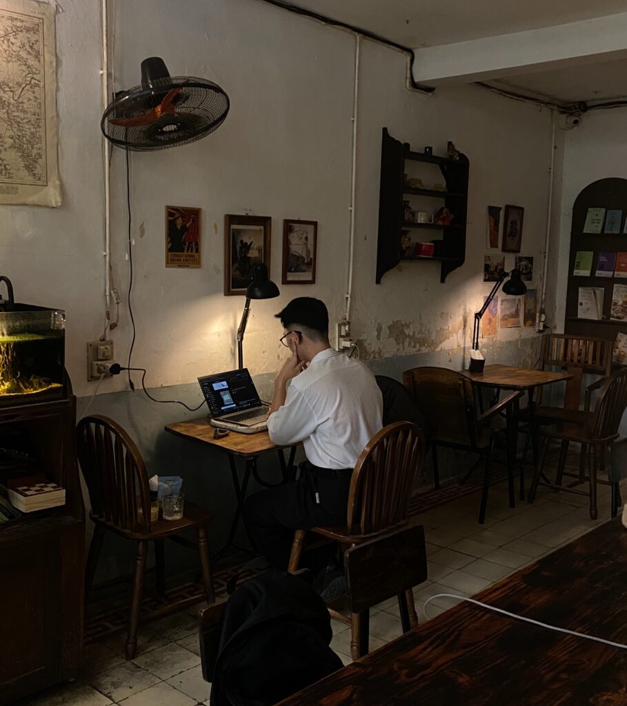 Man working from laptop in cafe of Hanoi